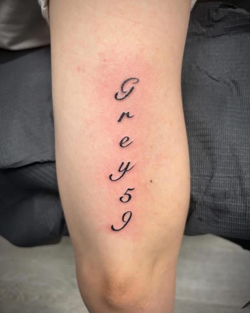 Script name tattoo reading Greysen on a calf