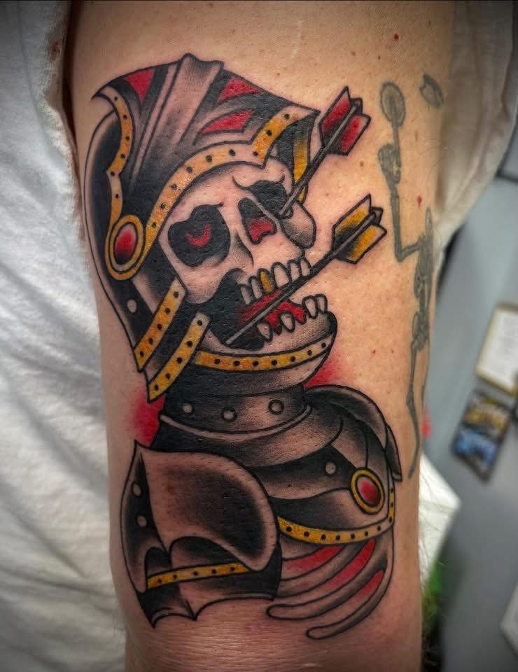 Traditional color knight skull with arrow tattoo on an arm