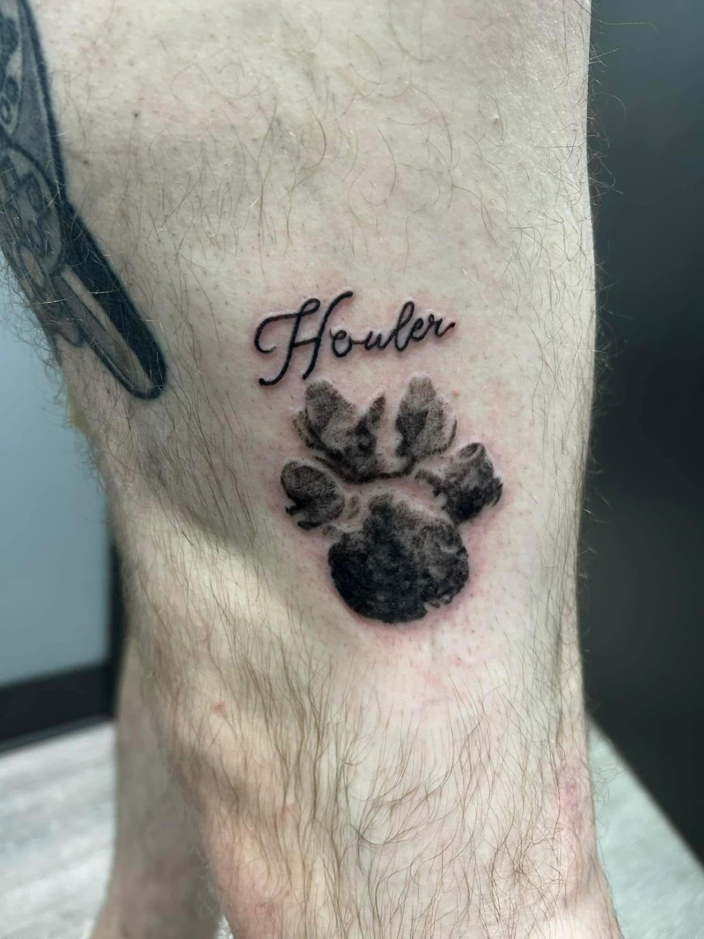 Pet paw print with script name tattoo
