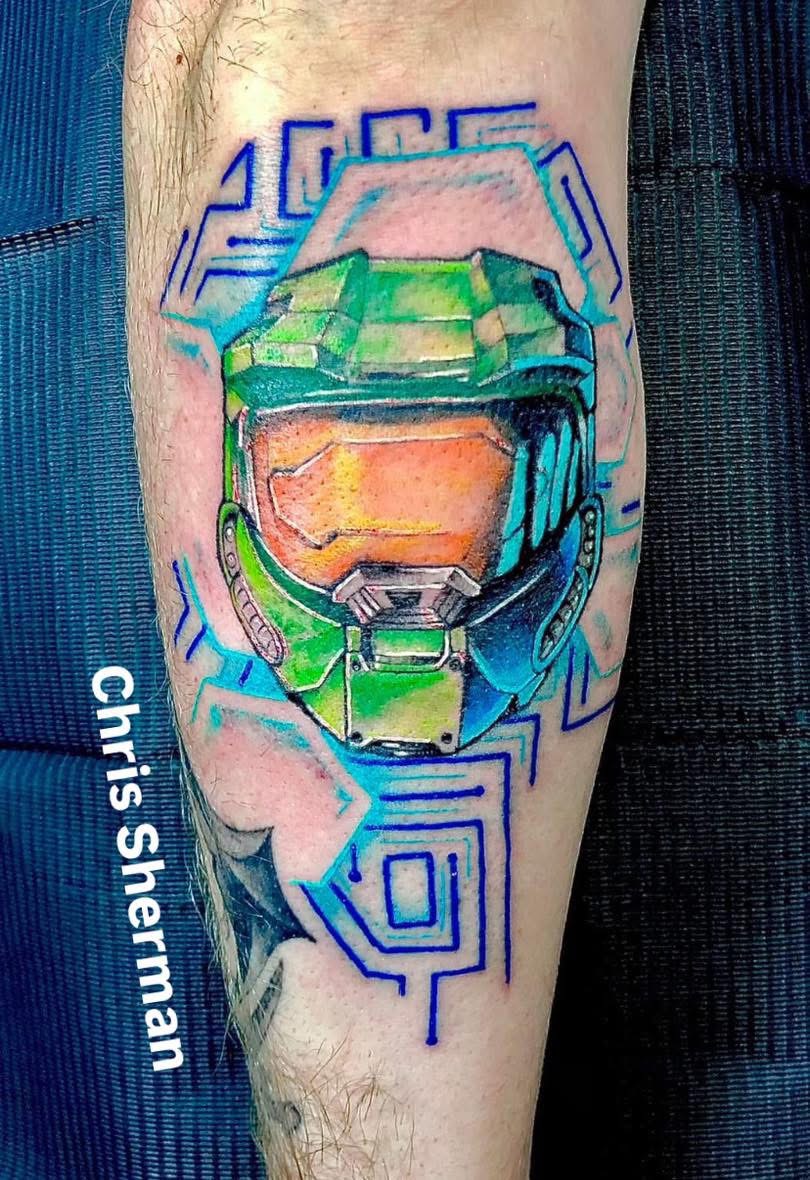 Color video game helmet tattoo on a calf