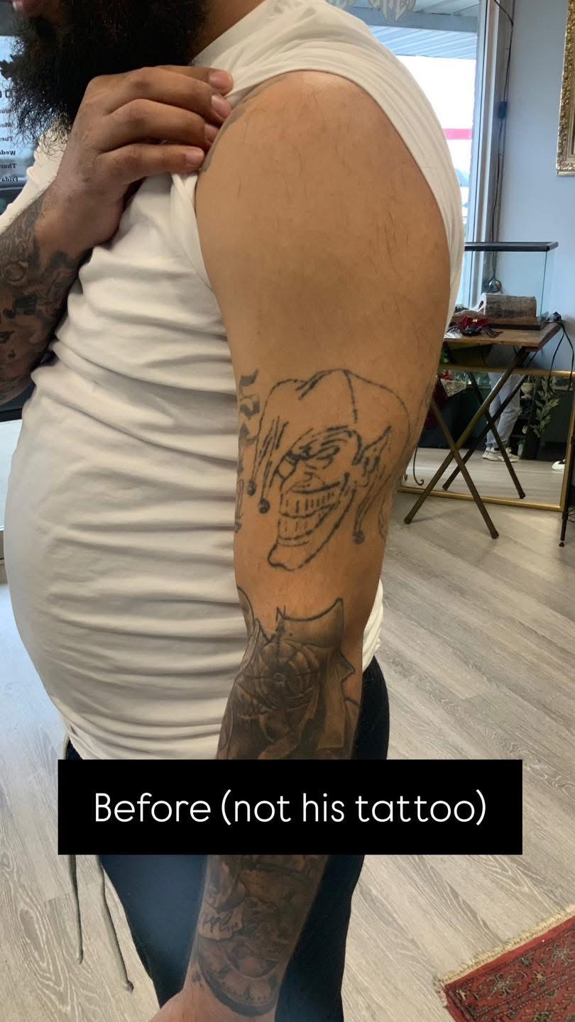 Before: faded jester outline tattoo on an upper arm