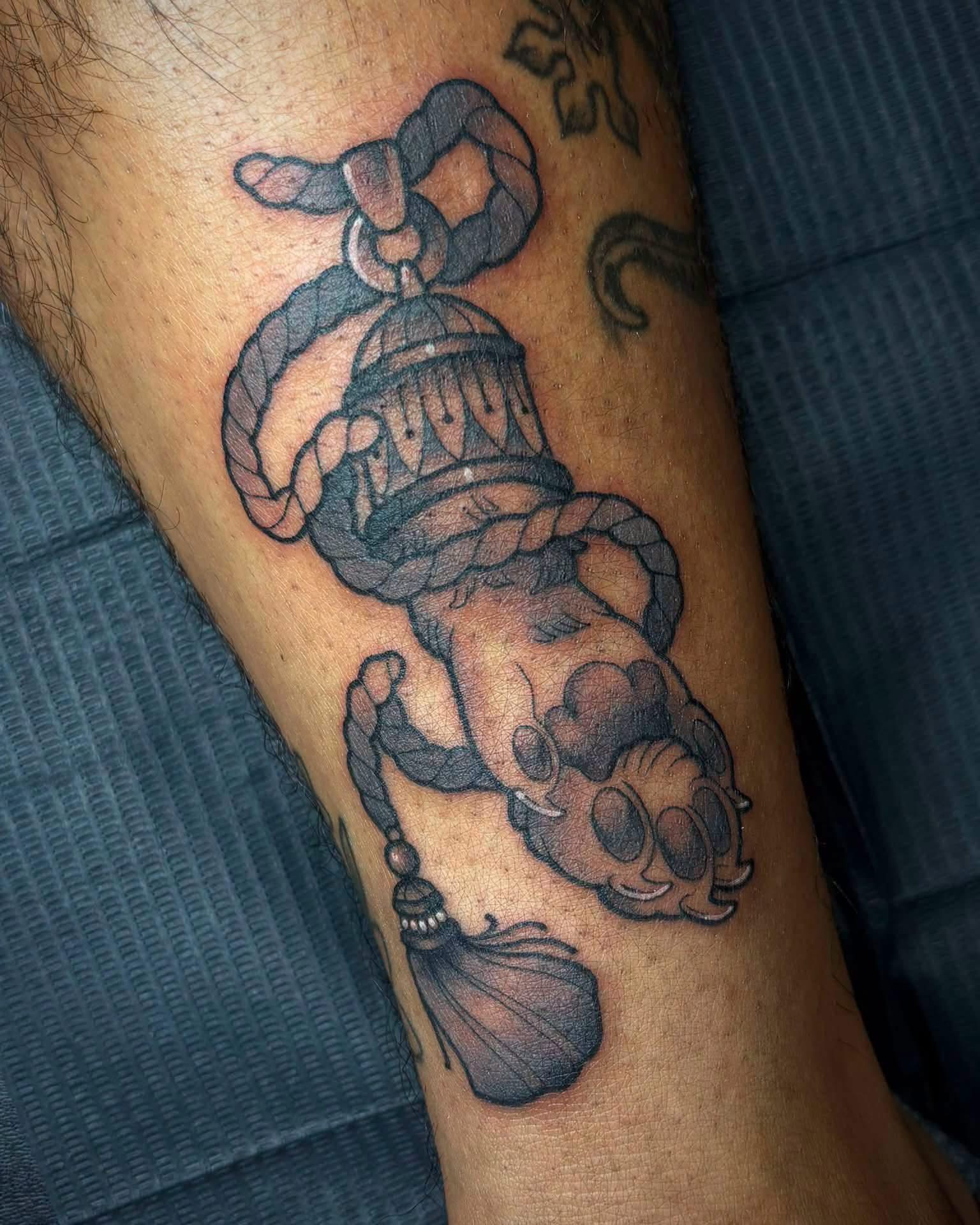 Black and grey genie lamp tattoo on a calf