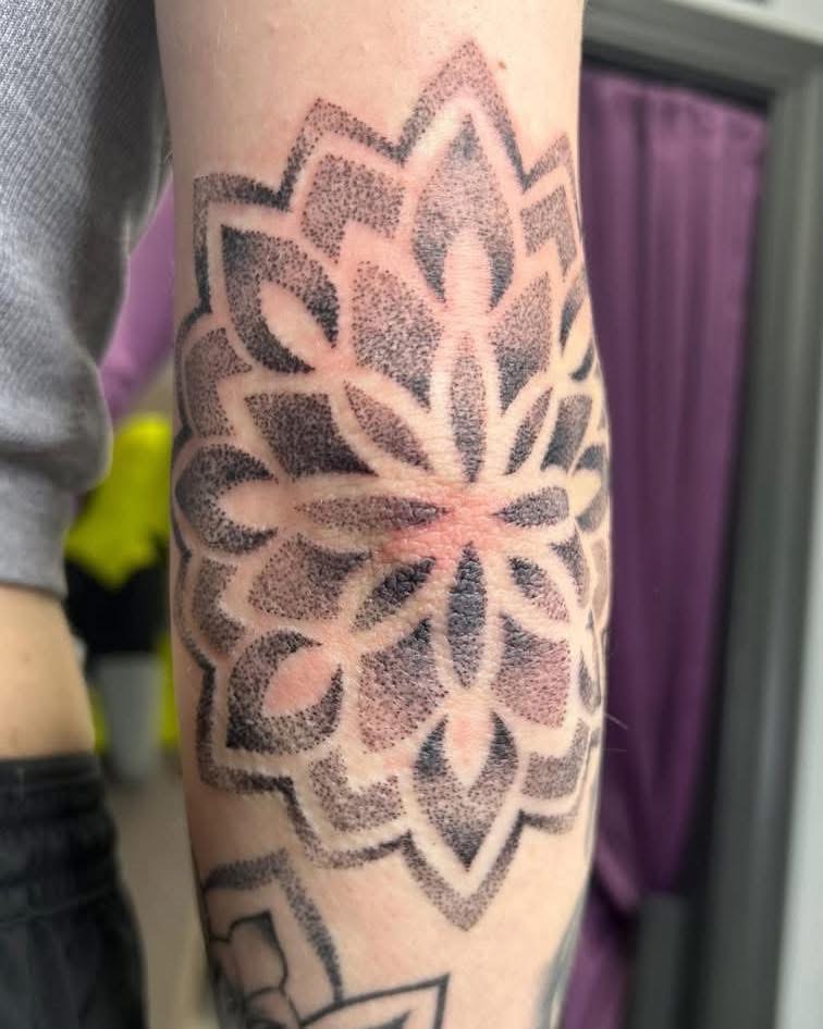 Dotwork mandala tattoo on a forearm
